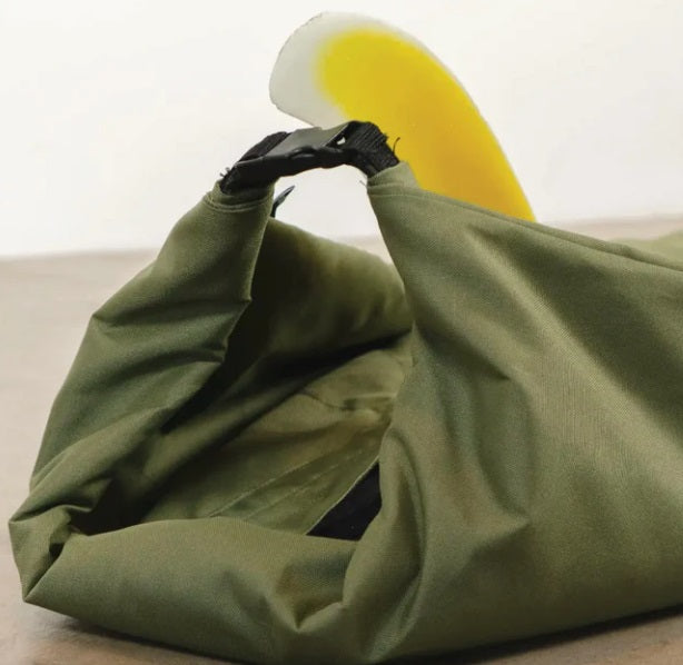 FARO Board Bags Olive Drab Sustainable Canvas Surfboard Bag on floor rolled up with center fin poking through.